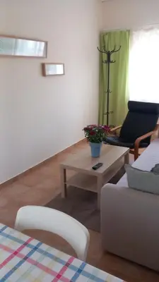 a living room with a couch and a coffee table at Pavlos apartment in Leondárion