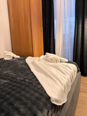a bed with two white towels on top of it at Modern studio apartment in Athens