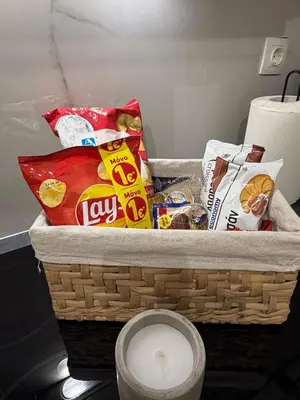 a basket filled with chips and snacks in a room at Modern studio apartment in Athens