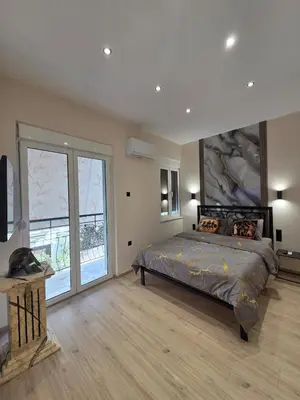 a bedroom with a bed and a large window at 3siblings Β2 in Athens