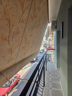 a red car parked on the side of a building at 3siblings Β2 in Athens