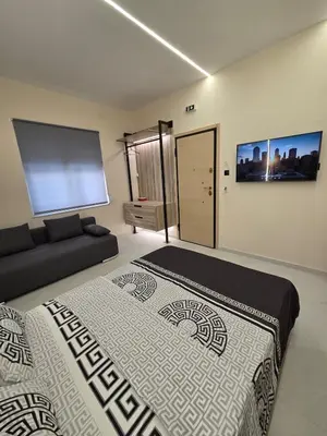 a bedroom with a large bed and a couch at 3siblings A2 in Athens
