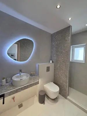 a bathroom with a sink and a toilet and a mirror at 3siblings A2 in Athens