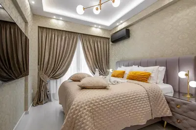 a bedroom with a large bed with yellow pillows at Crystal Parthenon - Luxury Design Apartment near Acropolis in Athens