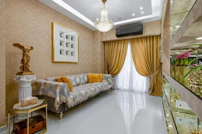 a living room with a couch and a chandelier at Crystal Parthenon - Luxury Design Apartment near Acropolis in Athens