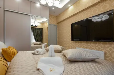 a bedroom with two beds and a tv on the wall at Crystal Parthenon - Luxury Design Apartment near Acropolis in Athens