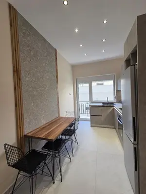 a kitchen and dining room with a table and chairs at 3siblings A1 in Athens