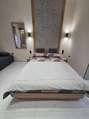 a bedroom with a large bed with a mirror at 3siblings A1 in Athens