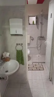 a bathroom with a sink and a shower and a toilet at House Marios airport 3 in Spáta