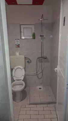 a bathroom with a toilet and a shower at House Marios airport 3 in Spáta