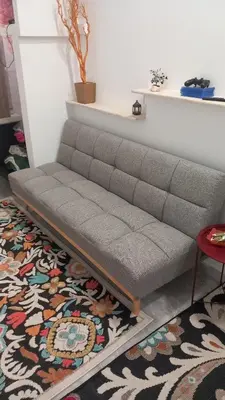a couch in a living room with a rug at House Marios airport 3 in Spáta