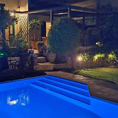 a swimming pool in a yard at night at Villa Pepy in Áyios Konstandínos