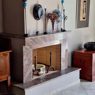 a living room with a brick fireplace at Villa Pepy in Áyios Konstandínos