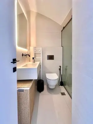 a white bathroom with a toilet and a sink at 2BR Sea View Loft with private Jacuzzi in Riviera in Athens