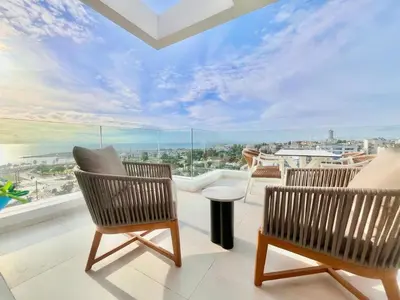 a balcony with two chairs and a view of the ocean at 2BR Sea View Loft with private Jacuzzi in Riviera in Athens