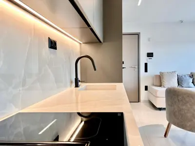 a kitchen with a sink and a couch in a room at 2BR Sea View Loft with private Jacuzzi in Riviera in Athens
