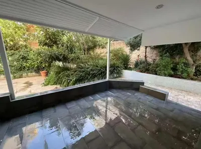 an empty house with a view of a garden at Seaside Comfort Stay apartment in Athens
