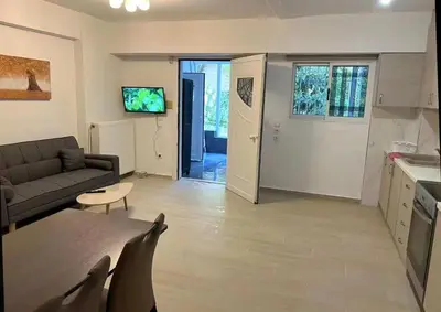 a living room with a couch and a table at Seaside Comfort Stay apartment in Athens