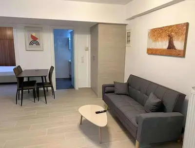 a living room with a couch and a table at Seaside Comfort Stay apartment in Athens
