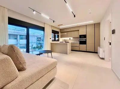 a living room with a couch and a kitchen at Athenian Riviera Hideaway, 1 BR in Glyfada in Athens