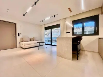 a living room with a counter and a couch at Athenian Riviera Hideaway, 1 BR in Glyfada in Athens