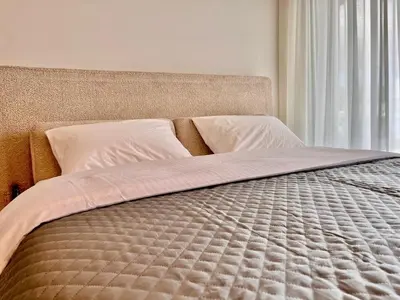 a bed in a bedroom with a large window at Athenian Riviera Hideaway, 1 BR in Glyfada in Athens