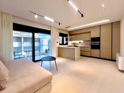 a living room with a couch and a kitchen at Athenian Riviera Hideaway, 1 BR in Glyfada in Athens