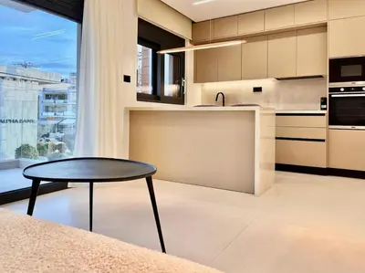 a kitchen with a table and a counter top at Athenian Riviera Hideaway, 1 BR in Glyfada in Athens