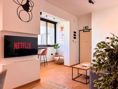 a living room with a tv on a wall at Top Floor Elegant Escape in Glyfada Center in Athens