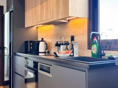 a kitchen with a sink and a counter top at Top Floor Elegant Escape in Glyfada Center in Athens