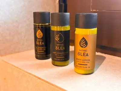 three bottles of yellow and black glue sitting on a shelf at Top Floor Elegant Escape in Glyfada Center in Athens