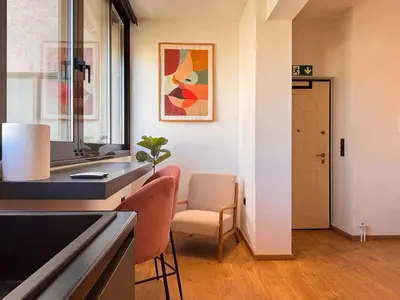 a kitchen with a counter and a chair and a table at Top Floor Elegant Escape in Glyfada Center in Athens