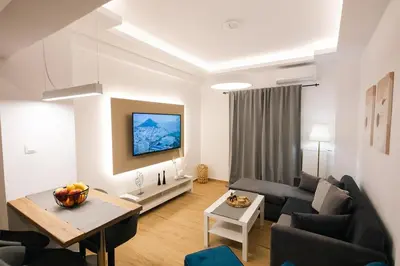 a living room with a couch and a table at Vote Athens Apartment in Athens