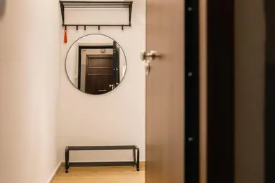 a mirror on a wall next to a door at Vote Athens Apartment in Athens