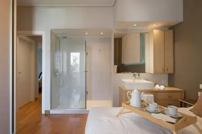 a bathroom with a shower and a sink in a room at Elegant 2BR Apartment near Metro, Sunny & Spacious in Athens