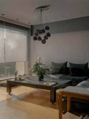 a living room with a couch and a table at Elegant 2BR Apartment near Metro, Sunny & Spacious in Athens