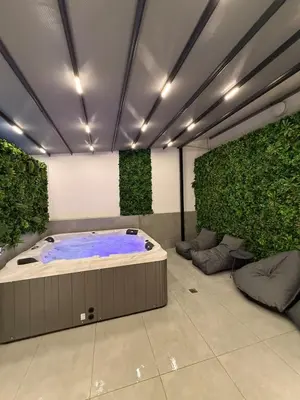 a hot tub in a room with green plants at City Center Jacuzzi Lux 2master BD apartment in Athens