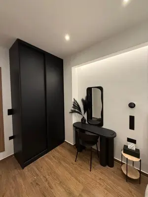 a room with a black desk and a mirror at City Center Jacuzzi Lux 2master BD apartment in Athens