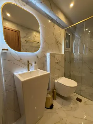 a bathroom with a sink and a toilet and a mirror at City Center Jacuzzi Lux 2master BD apartment in Athens
