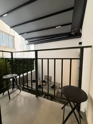 a balcony with two chairs and a table on it at City Center Jacuzzi Lux 2master BD apartment in Athens