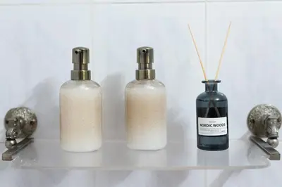 three bottles sitting on a shelf next to a vase at 2 KING beds, 81 sqm, Downtown near Metro in Athens