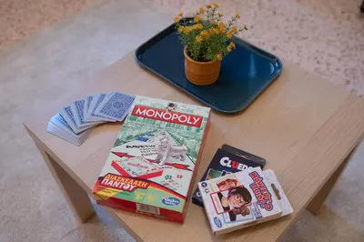 a table with books and a pot of flowers on it at 2 KING beds, 81 sqm, Downtown near Metro in Athens