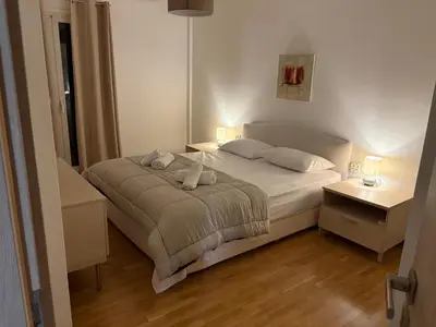 a bedroom with a bed with two pillows on it at Pireaus Center Apartment in Piraeus