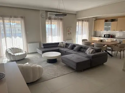 a living room with a couch and a table at Pireaus Center Apartment in Piraeus
