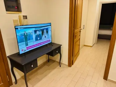 a television sitting on a table in a room at Brown Port 2 bedroom 2wc flat in Piraeus