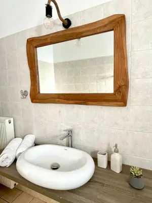 a bathroom with a white sink and a mirror at Sky View Athens Airport Apartment in Spáta