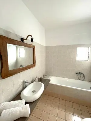 a bathroom with a tub and a toilet and a sink at Sky View Athens Airport Apartment in Spáta