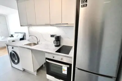 a kitchen with a stainless steel refrigerator and a sink at Athens View Studio Near Lycabettus Hill by MPS in Athens