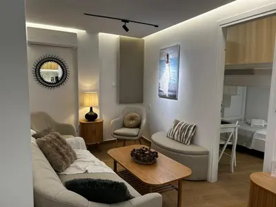 a living room with a couch and a table at Hephaestus by Heloni Apartments in Athens