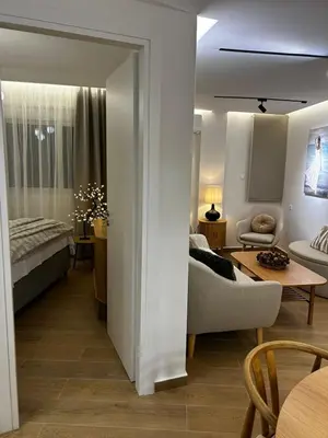 a living room with a couch and a bed at Hephaestus by Heloni Apartments in Athens